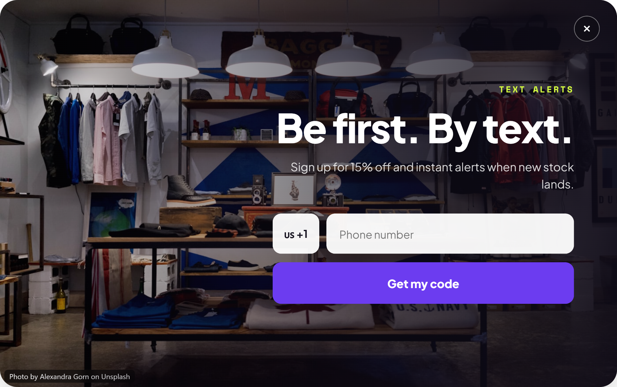 Popup over a menswear shop reading “Be first. By text.” with a phone field and a Get my code button