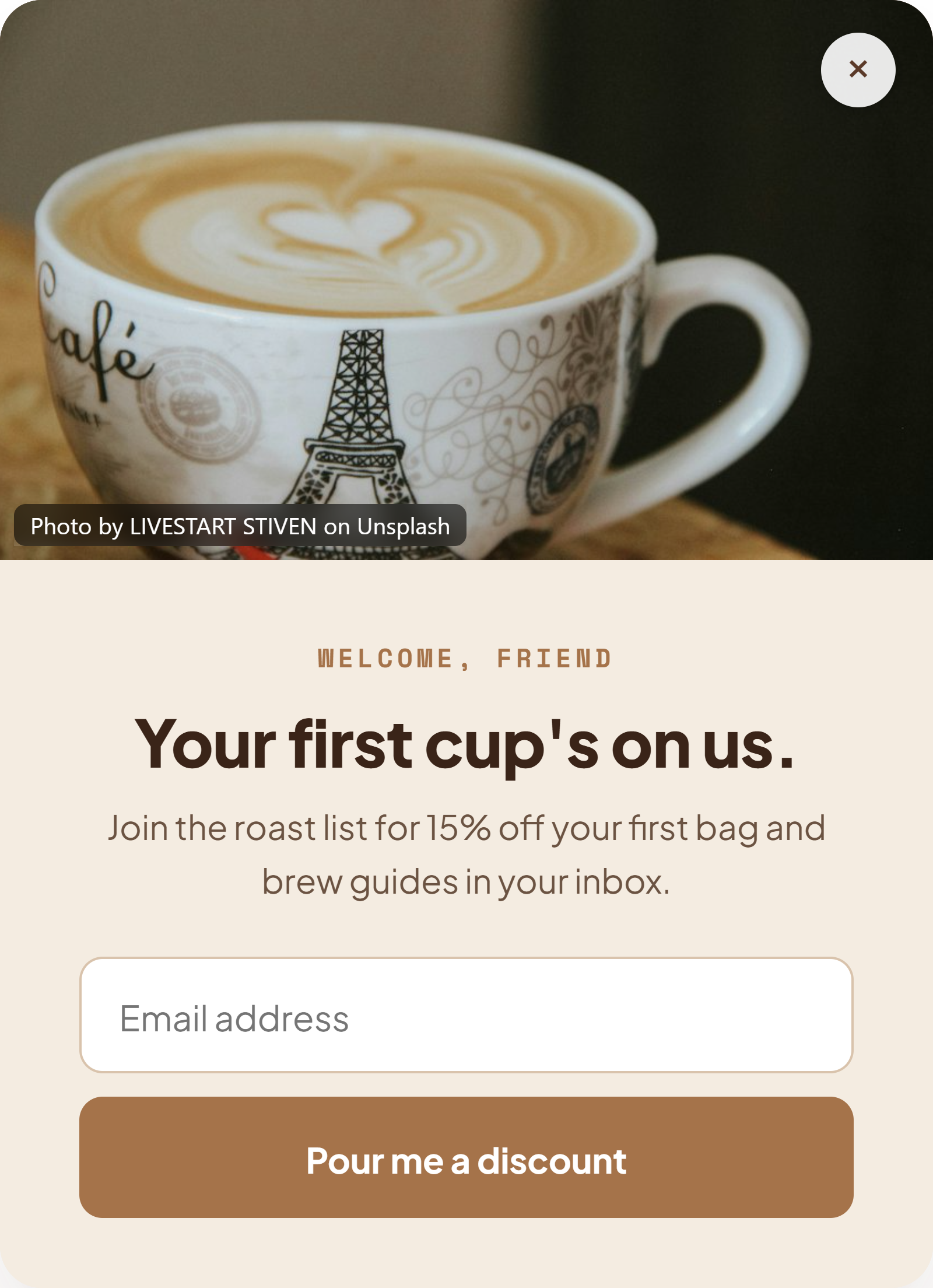 Vertical popup over a latte photo reading “Your first cup’s on us” with a Pour me a discount button